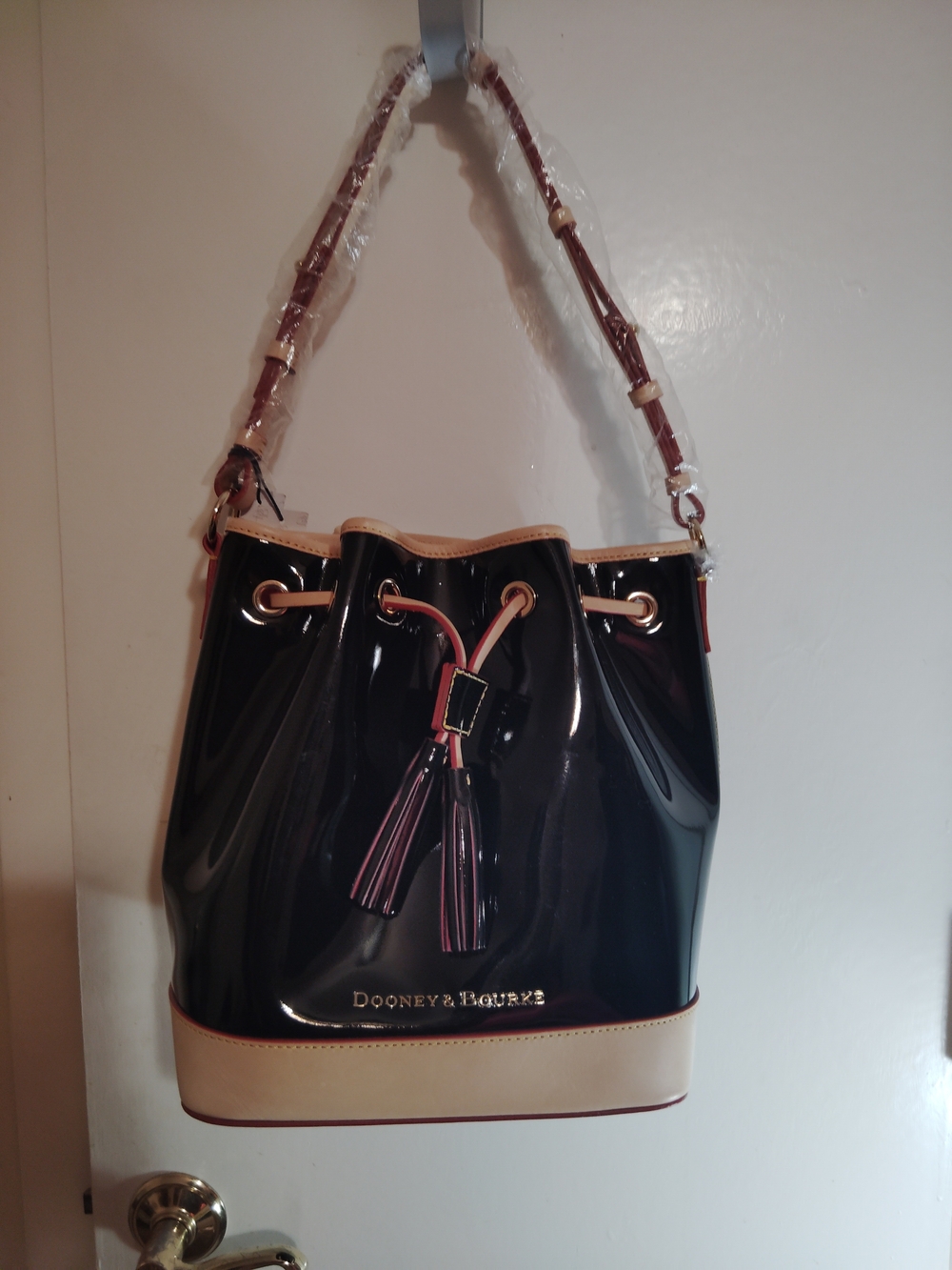 Dooney & Bourke Black Patent Leather Drawstring Bucket Bag with Cream Trim